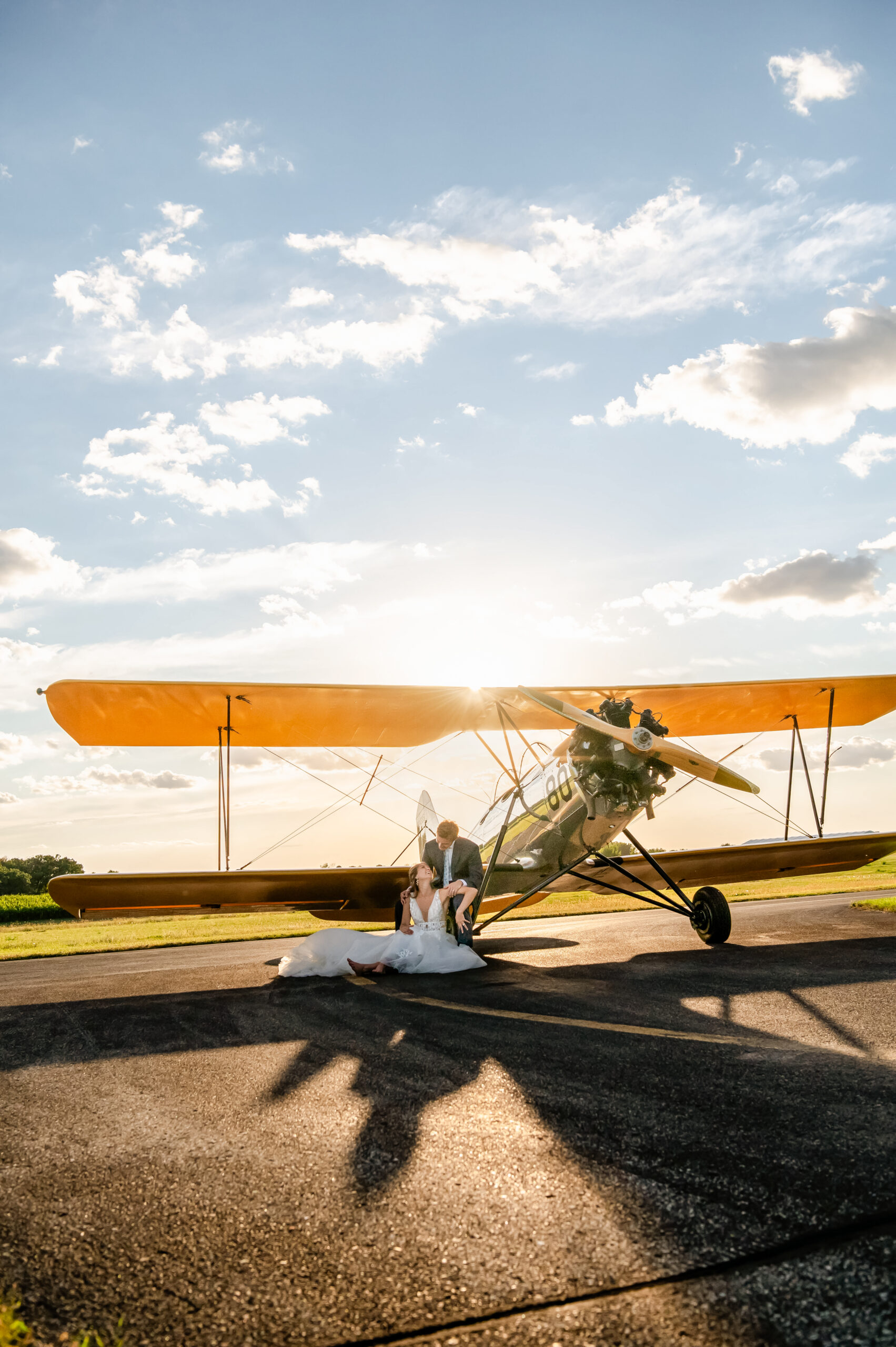 image of sunset behind airplane of wedding couple for destination elopement wedding photography _ captured by caitlin anne photos for joyfille stories