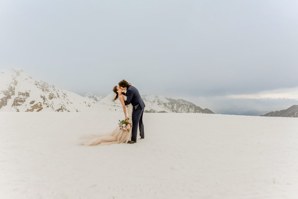 elopement photography for intimate weddings couple on mountains covered with snow