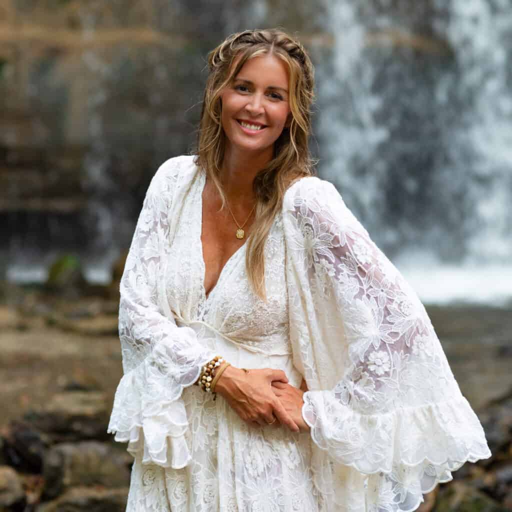 caitlin anne photographer headshot white boho dress with waterfall in minnesota